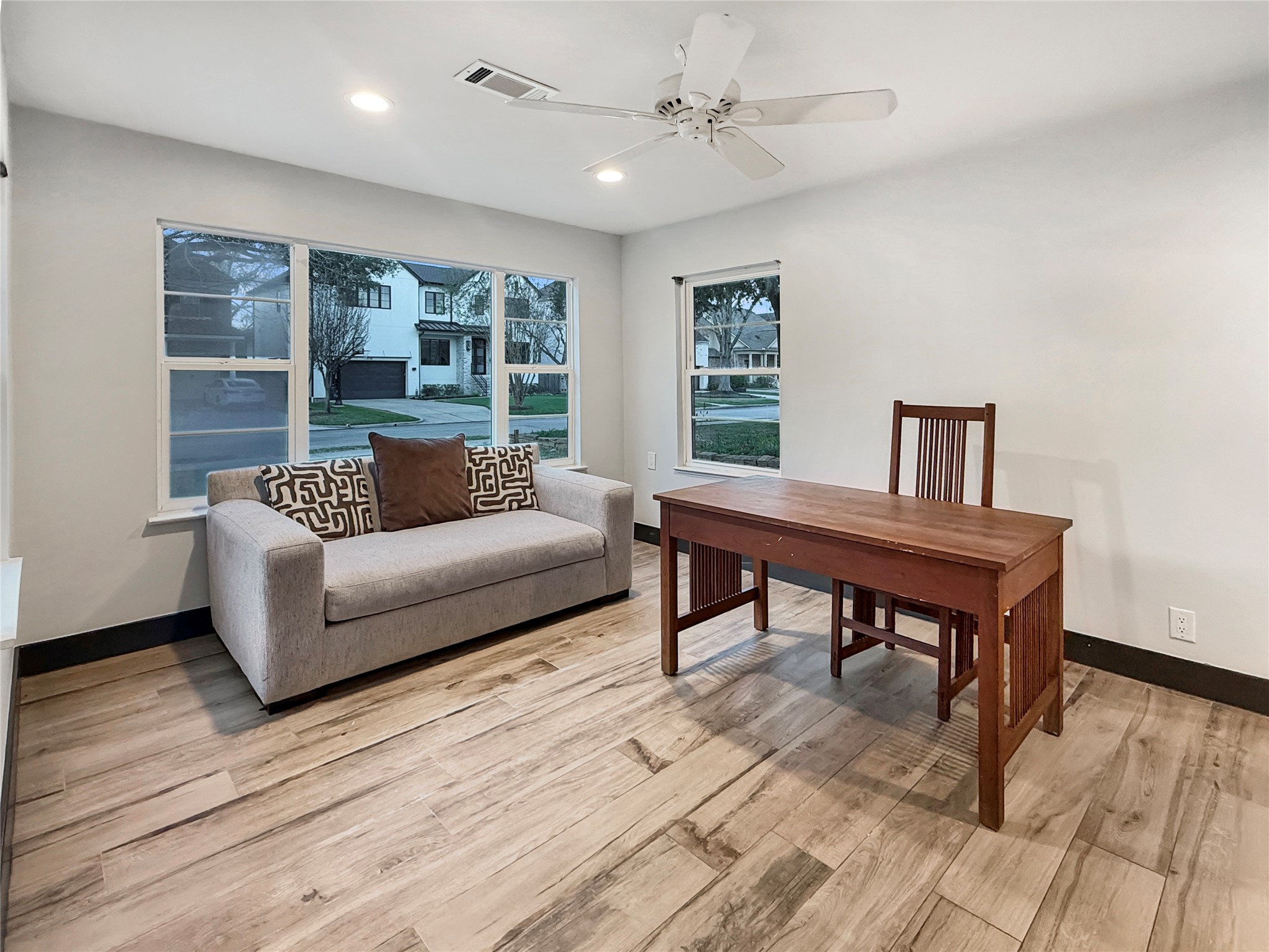 4521 Maple Street Bellaire, TX 77401 - Photo 5 of 36 Light-filled multi-use room with updated flooring and generous wall space, ideal for a study, sitting area, or creative workspace.