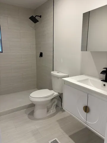 a white toilet sitting next to a bathroom sink