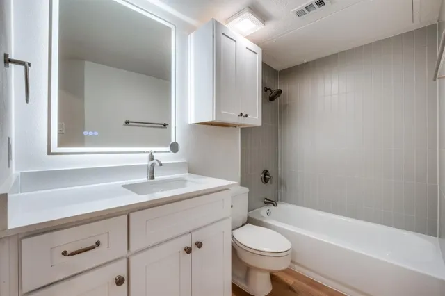 a bathroom with a sink a toilet and a bathtub
