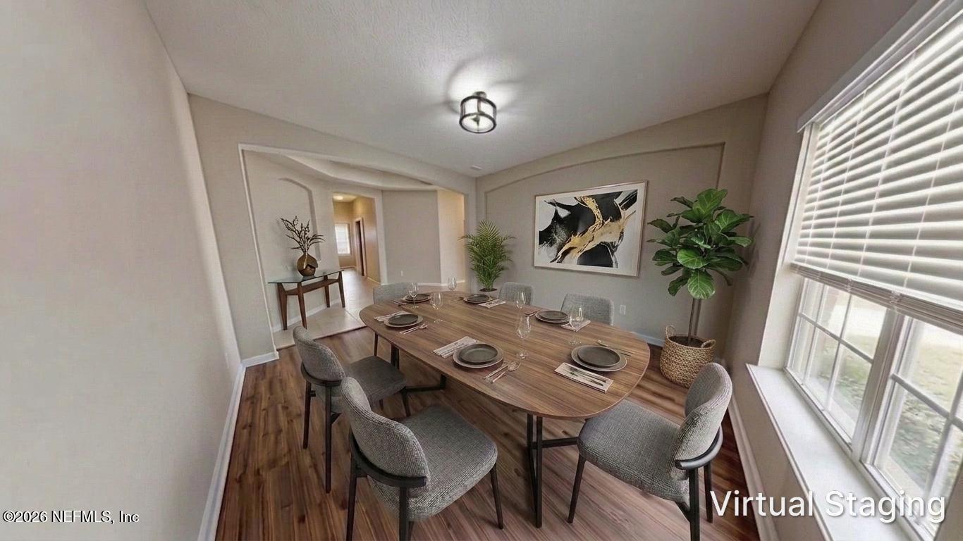 14454 Millhopper Road Jacksonville, FL 32258 - Photo 9 of 44 a view of a dining room with furniture window and wooden floor