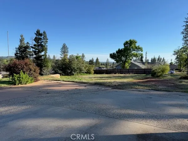 a view of dirt field with trees