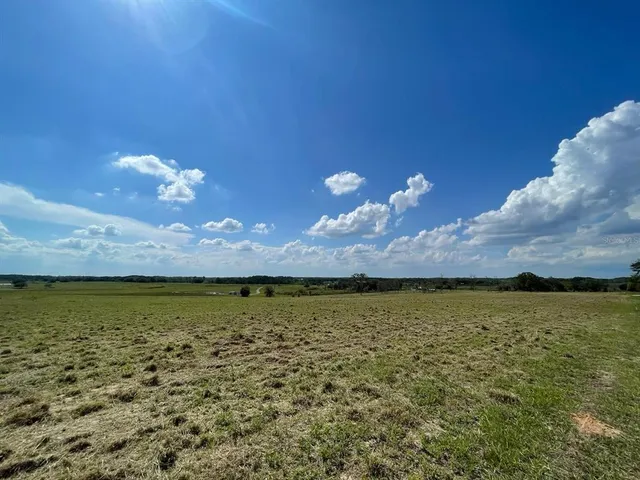 a bathroom with a granite countertop sink a mirror and shower