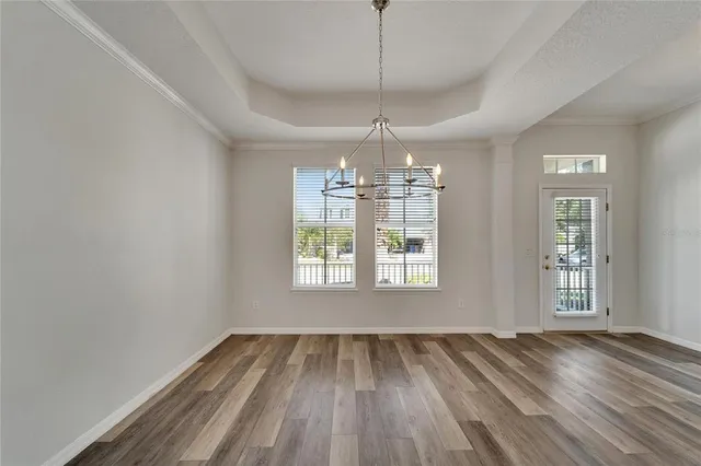 a view of a livingroom with wooden floor and a window