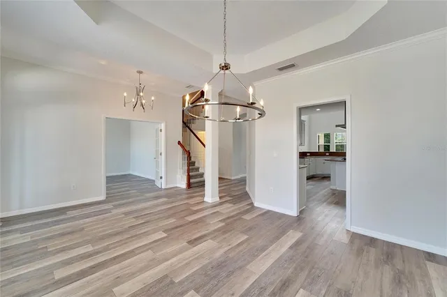 a view of empty room with wooden floor and fireplace