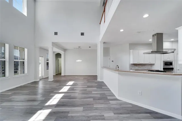 a kitchen with a sink stainless steel appliances and window