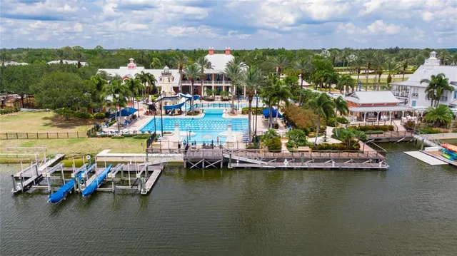 an aerial view of a house with a big yard and large tree