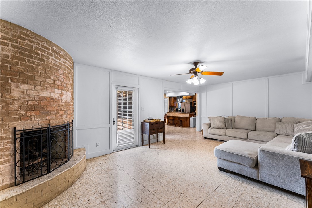 4325 St George Drive Corpus Christi, TX 78413 - Photo 13 of 22 a living room with furniture and a fireplace