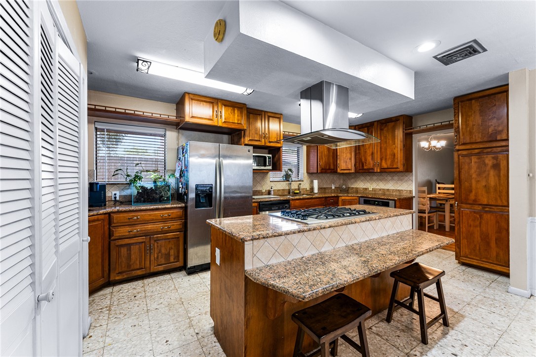 4325 St George Drive Corpus Christi, TX 78413 - Photo 15 of 22 a kitchen with stainless steel appliances granite countertop a stove refrigerator and a oven