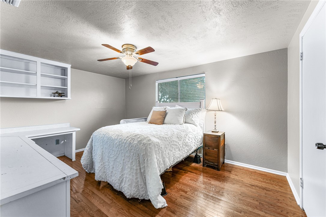 4325 St George Drive Corpus Christi, TX 78413 - Photo 18 of 22 a bedroom with a bed and a chandelier