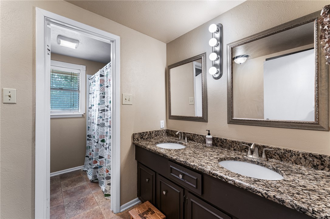 4325 St George Drive Corpus Christi, TX 78413 - Photo 19 of 22 a bathroom with a granite countertop sink and a mirror