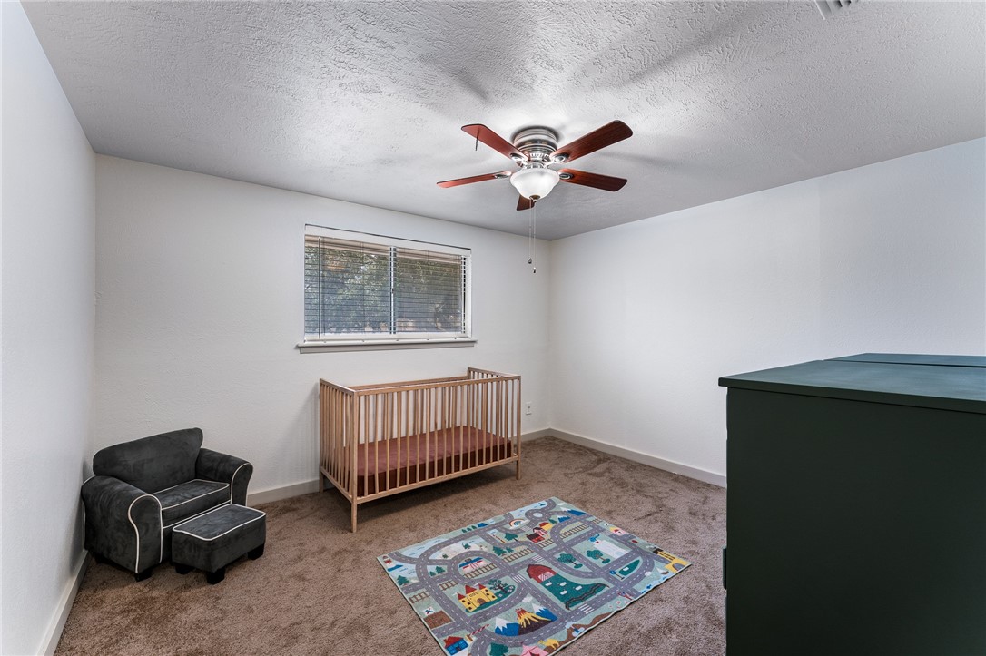 4325 St George Drive Corpus Christi, TX 78413 - Photo 20 of 22 a living room with baby crib furniture a rug and a window