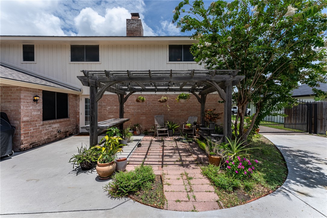 4325 St George Drive Corpus Christi, TX 78413 - Photo 4 of 22 a front view of a house with garden