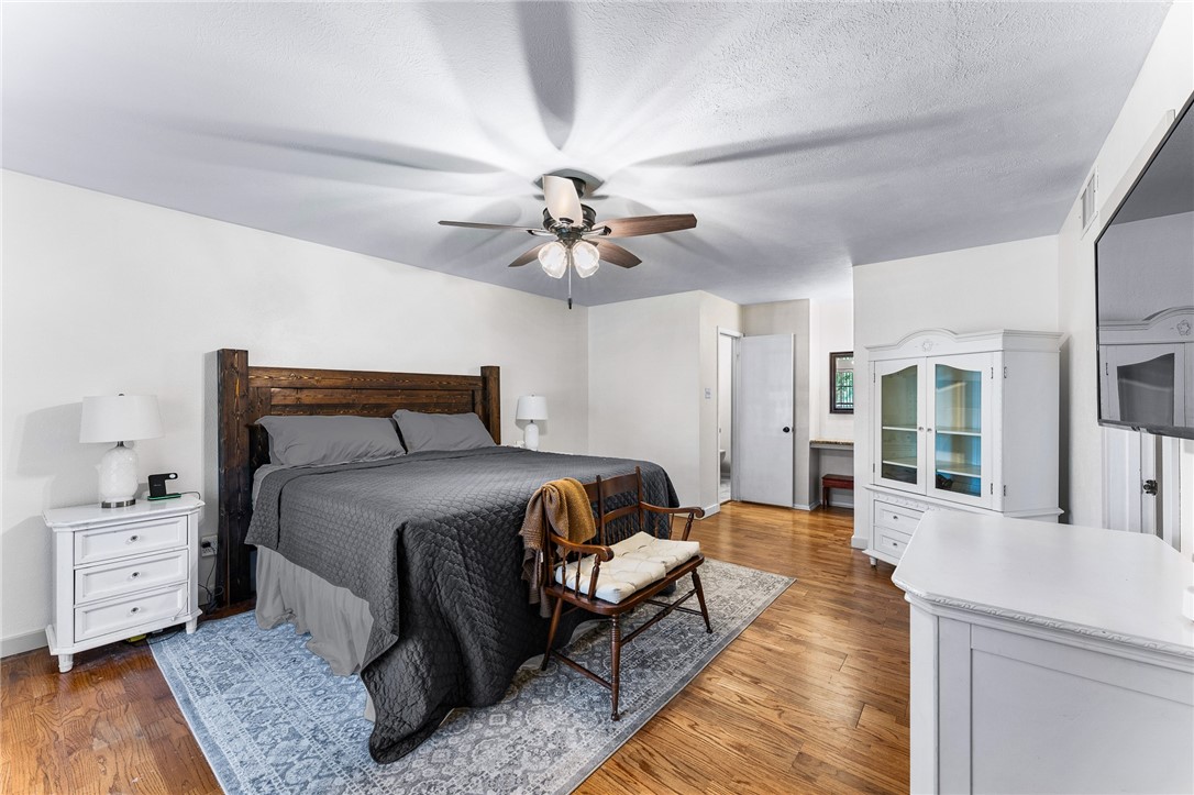 4325 St George Drive Corpus Christi, TX 78413 - Photo 5 of 22 a bedroom with a bed and a chandelier