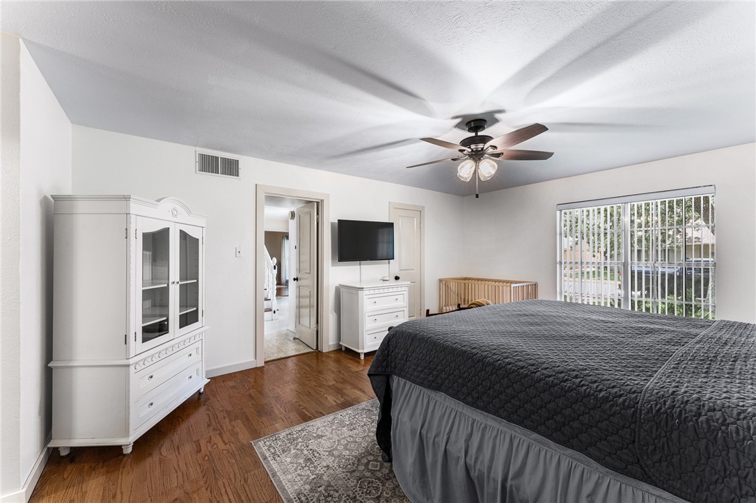 4325 St George Drive Corpus Christi, TX 78413 - Photo 6 of 22 a bedroom with a large bed a flat tv screen and dresser
