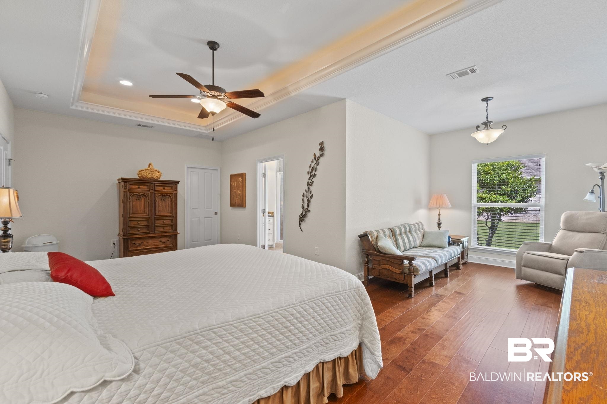 8664 Foxtail Loop Pensacola, FL 32526 - Photo 34 of 64 Bedroom featuring wood-type flooring, a raised ceiling, and a ceiling fan