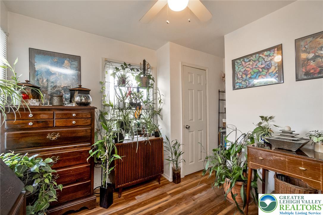 365 Rock Street Easton, PA 18042 - Photo 19 of 50 Natural light illuminates this cozy living space, boasting rich wood flooring and a refreshing ceiling fan.