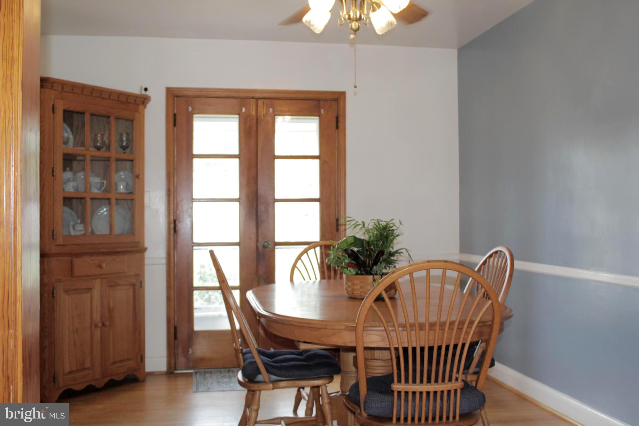 112 17th Avenue Baltimore, MD 21225 - Photo 12 of 40 a view of a dining room with furniture and chandelier