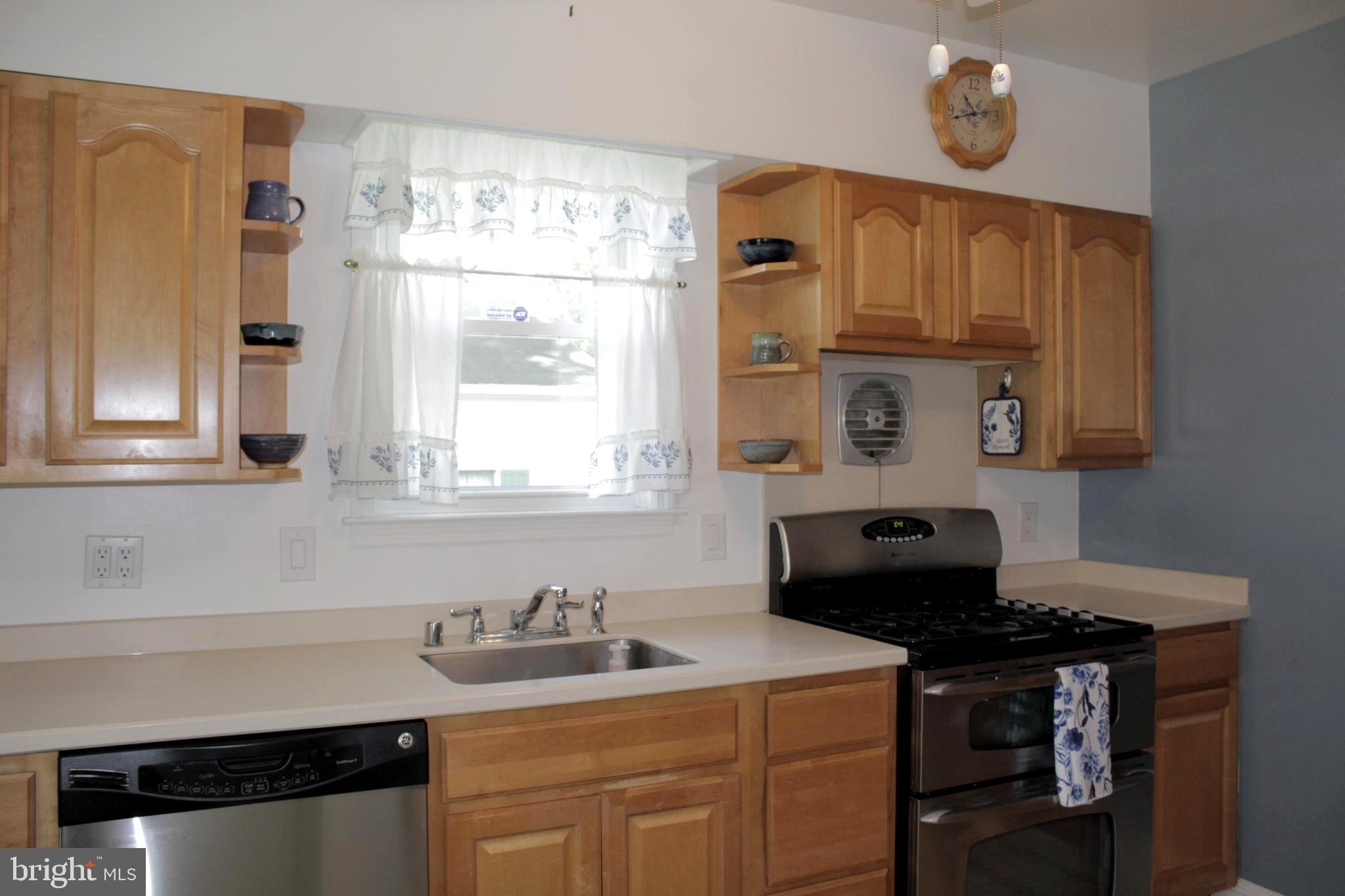112 17th Avenue Baltimore, MD 21225 - Photo 13 of 40 a kitchen with stainless steel appliances a sink a stove and a window
