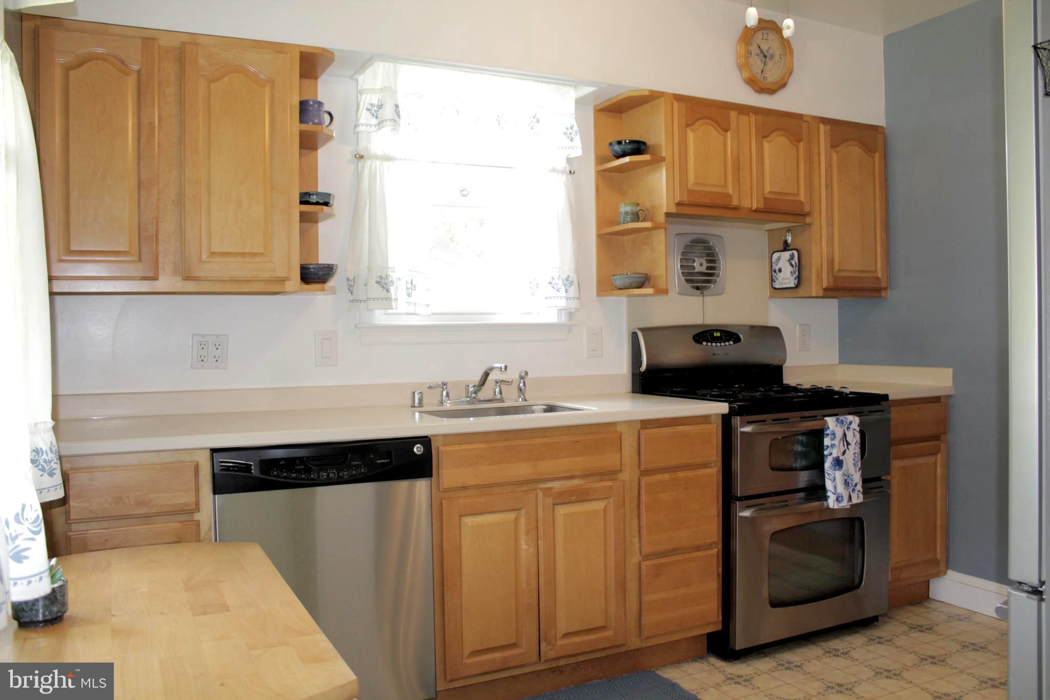 112 17th Avenue Baltimore, MD 21225 - Photo 14 of 40 a kitchen with stainless steel appliances granite countertop a sink and a stove