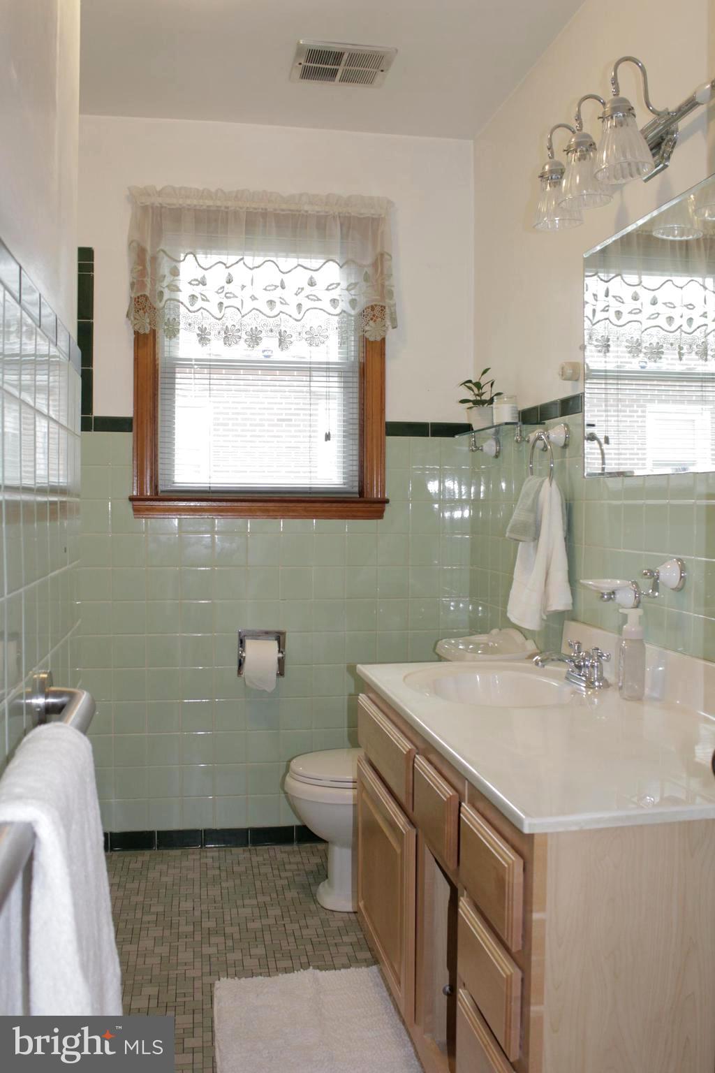 112 17th Avenue Baltimore, MD 21225 - Photo 17 of 40 a bathroom with a sink toilet and window