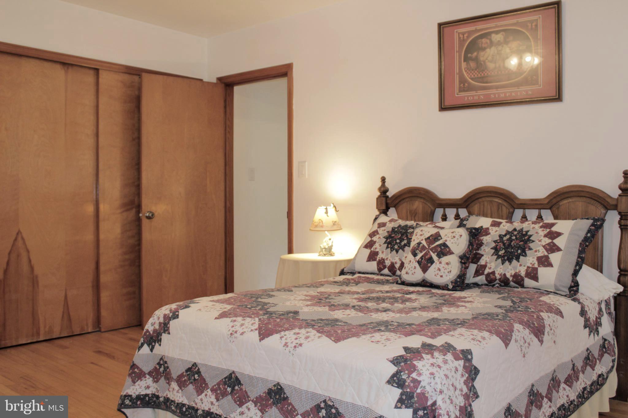 112 17th Avenue Baltimore, MD 21225 - Photo 18 of 40 a bedroom with a bed and a window