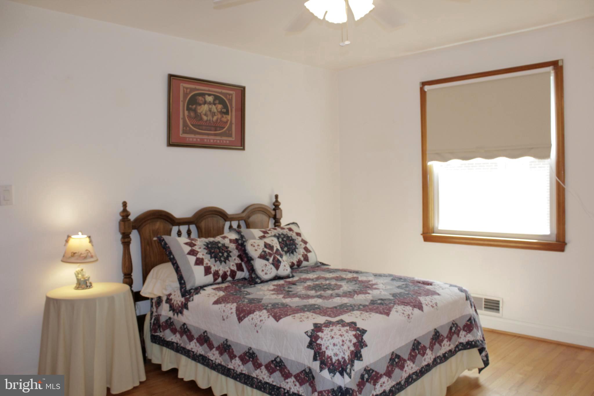 112 17th Avenue Baltimore, MD 21225 - Photo 19 of 40 a bedroom with bed and a window