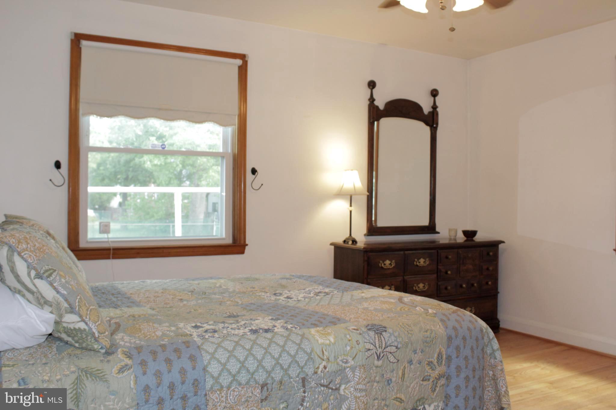 112 17th Avenue Baltimore, MD 21225 - Photo 20 of 40 a bedroom with a bed and a window