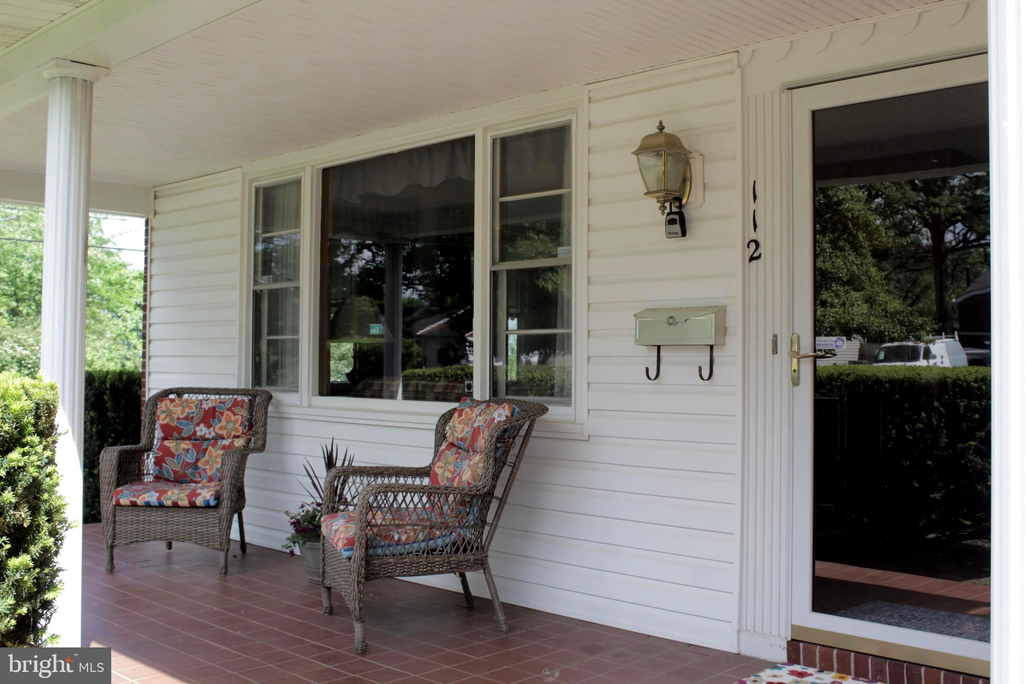 112 17th Avenue Baltimore, MD 21225 - Photo 2 of 40 a view of a house with a porch and furniture