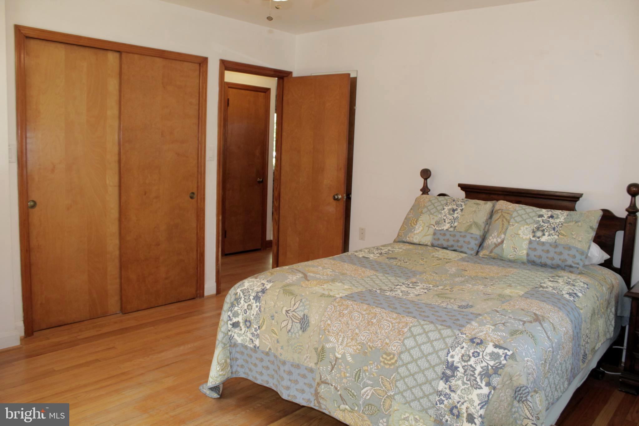 112 17th Avenue Baltimore, MD 21225 - Photo 22 of 40 a bedroom with a bed and wooden floor