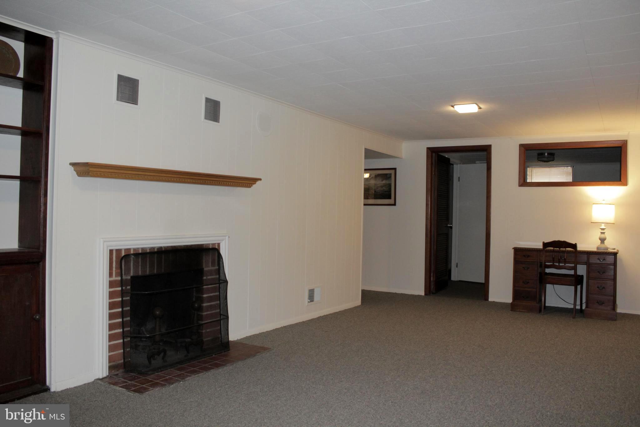112 17th Avenue Baltimore, MD 21225 - Photo 31 of 40 a view of an empty room with furniture and fireplace