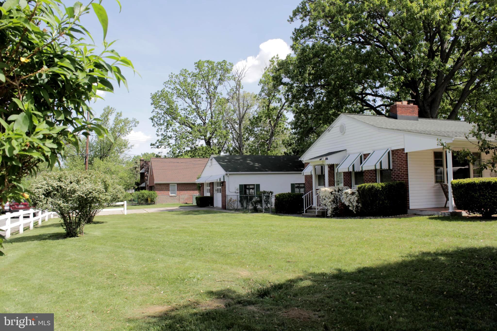 112 17th Avenue Baltimore, MD 21225 - Photo 35 of 40 a view of a house with a big yard and large trees