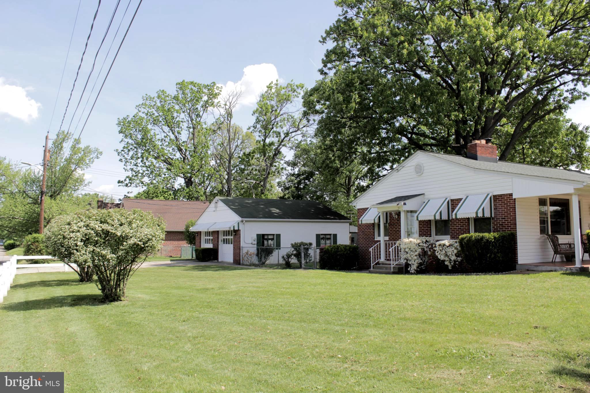 112 17th Avenue Baltimore, MD 21225 - Photo 36 of 40 a front view of house with yard and trees in the background