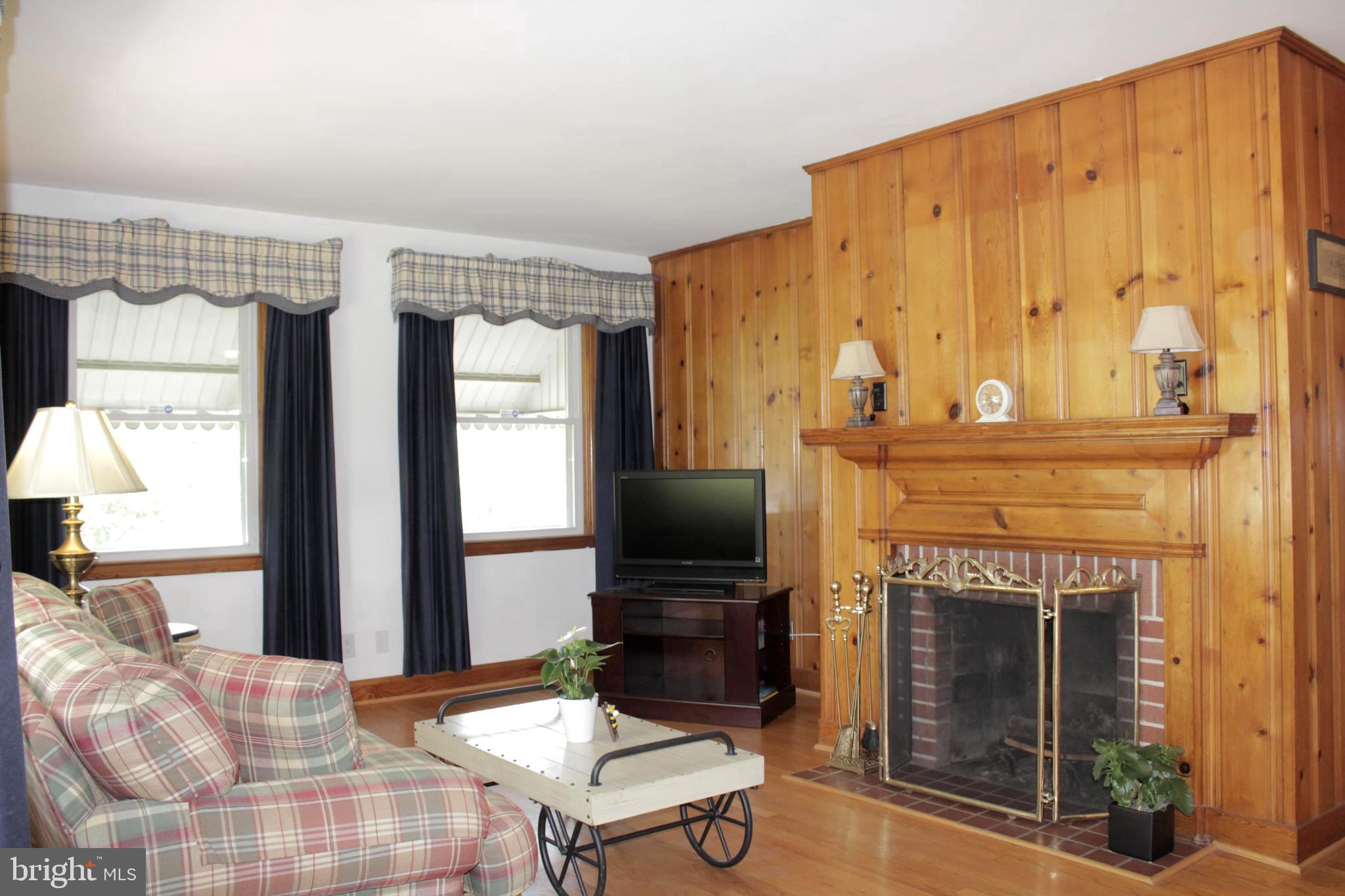 112 17th Avenue Baltimore, MD 21225 - Photo 8 of 40 a living room with furniture a flat screen tv and a fireplace