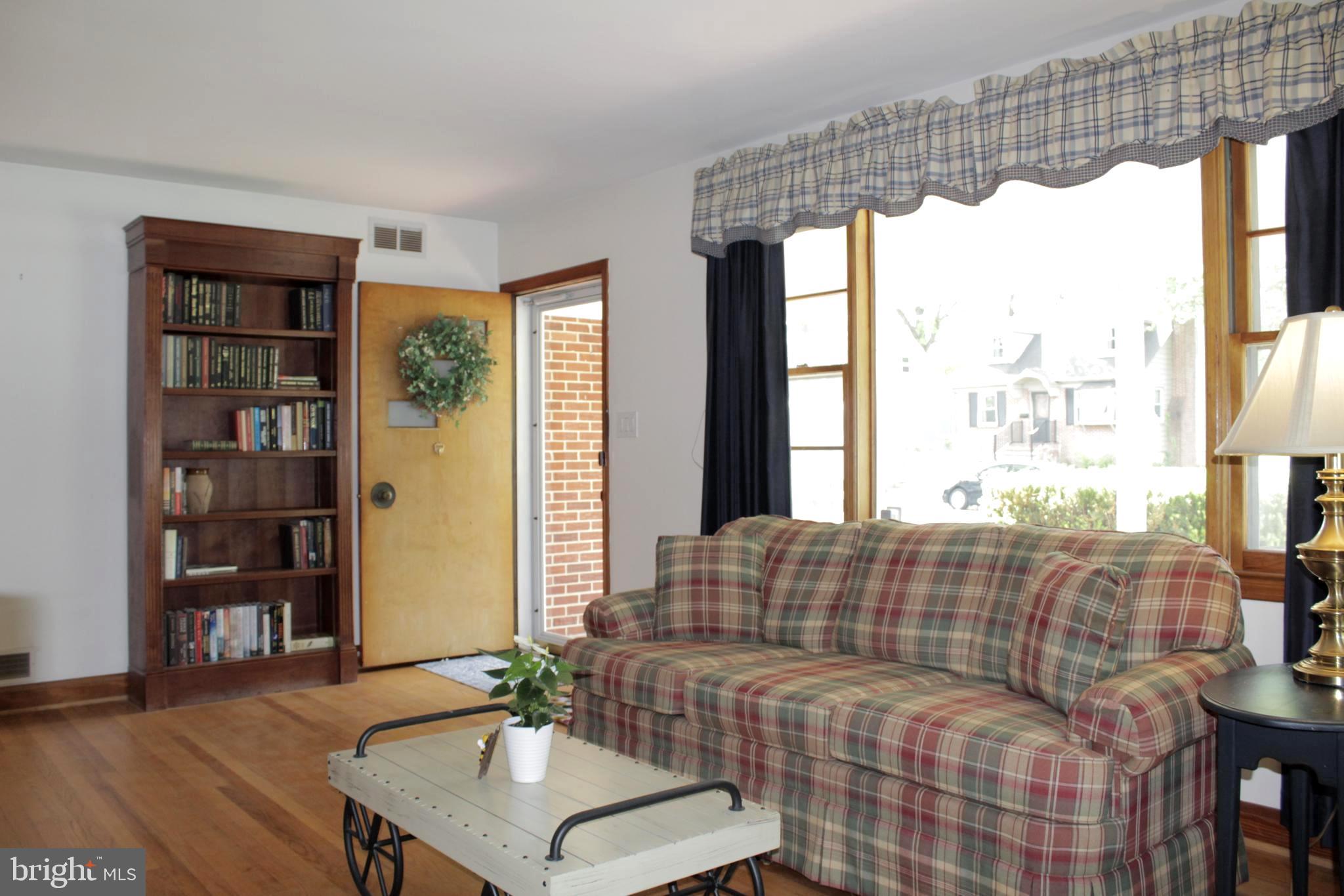 112 17th Avenue Baltimore, MD 21225 - Photo 9 of 40 a living room with furniture and a large window