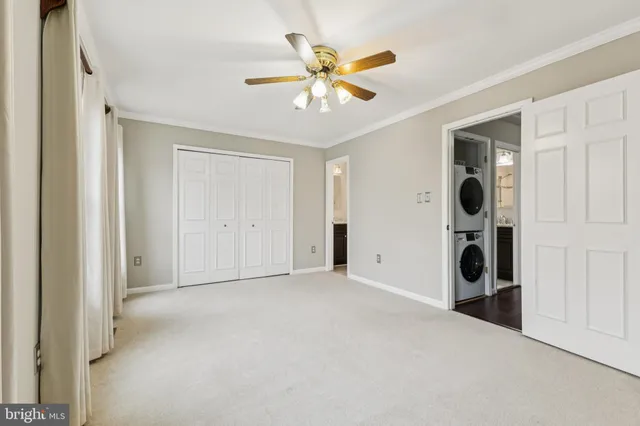 an empty room with closet and windows