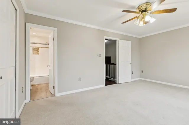 an empty room with closet and a chandelier fan