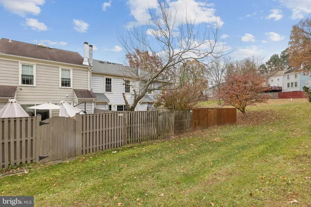 a view of a backyard with large trees