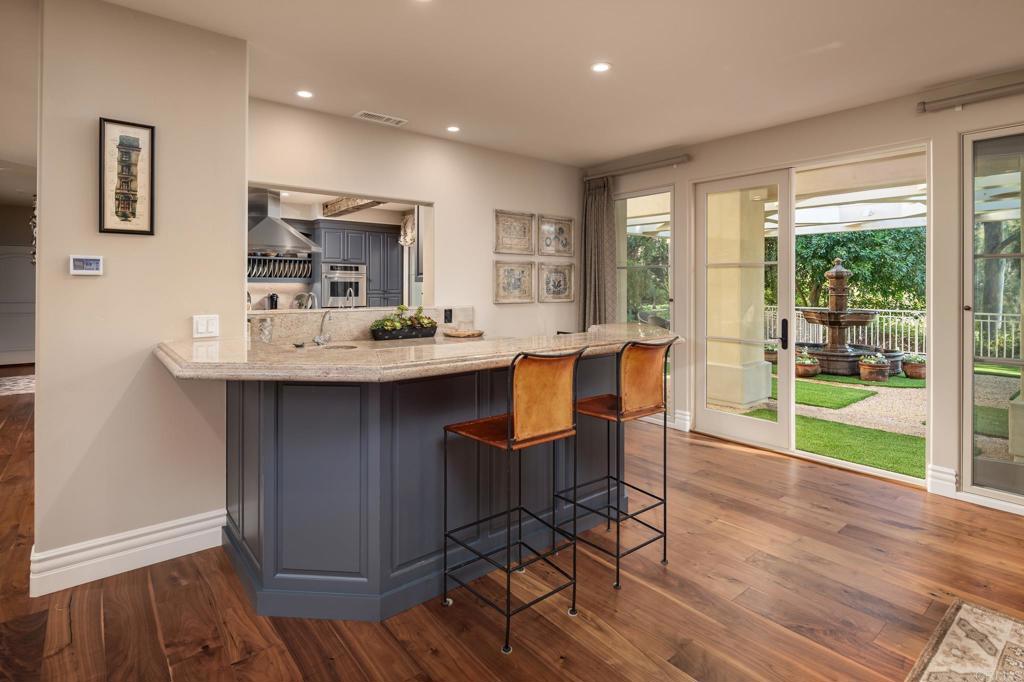 14479 Emerald Lane Rancho Santa Fe, CA 92067 - Photo 14 of 52 a dining hall with stainless steel appliances granite countertop a coffee table and chairs in it