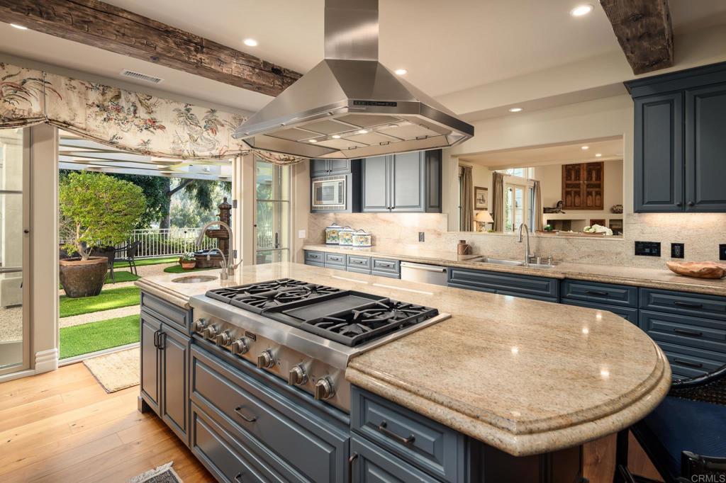14479 Emerald Lane Rancho Santa Fe, CA 92067 - Photo 18 of 52 a kitchen with stainless steel appliances granite countertop a stove a sink and a granite counter tops