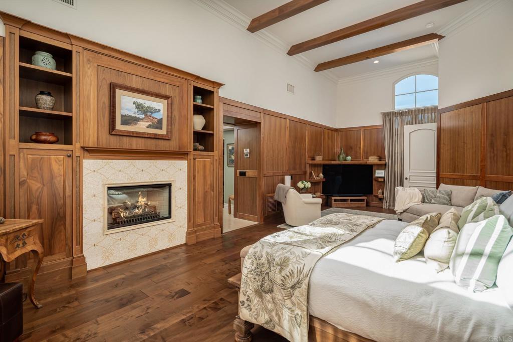 14479 Emerald Lane Rancho Santa Fe, CA 92067 - Photo 21 of 52 a bedroom with a bed a fireplace and a television