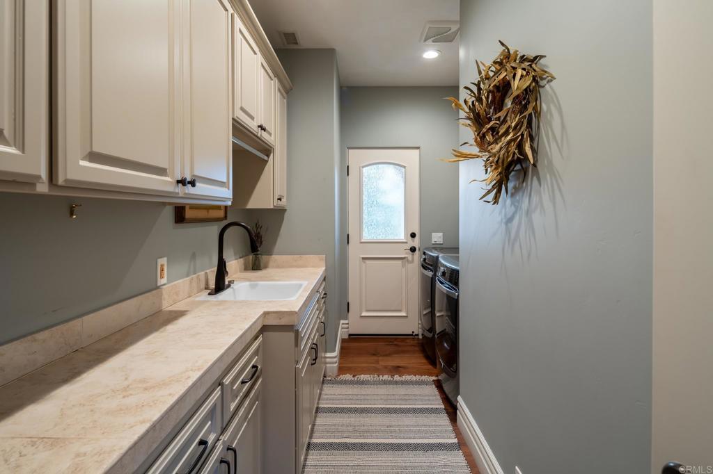 14479 Emerald Lane Rancho Santa Fe, CA 92067 - Photo 35 of 52 a kitchen with a sink and cabinets