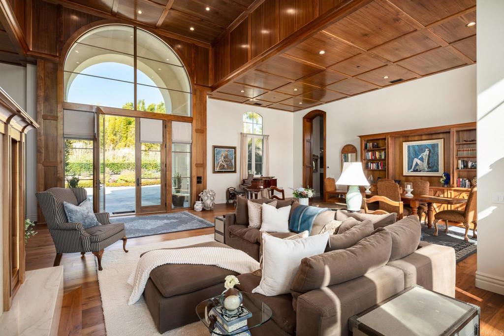 14479 Emerald Lane Rancho Santa Fe, CA 92067 - Photo 8 of 52 a living room with furniture a large window and wooden floor