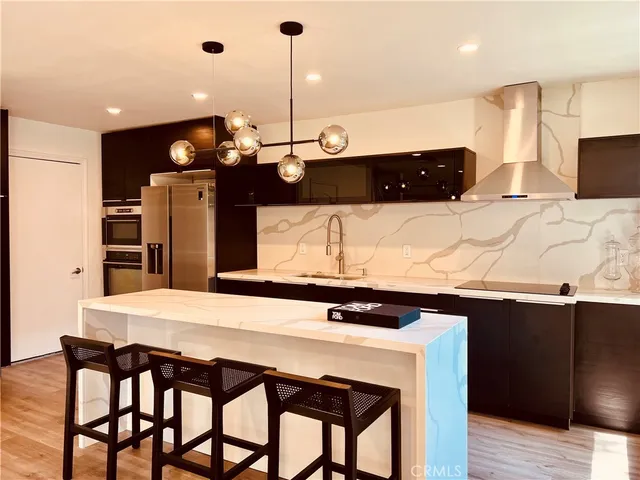 a kitchen with a table chairs and refrigerator