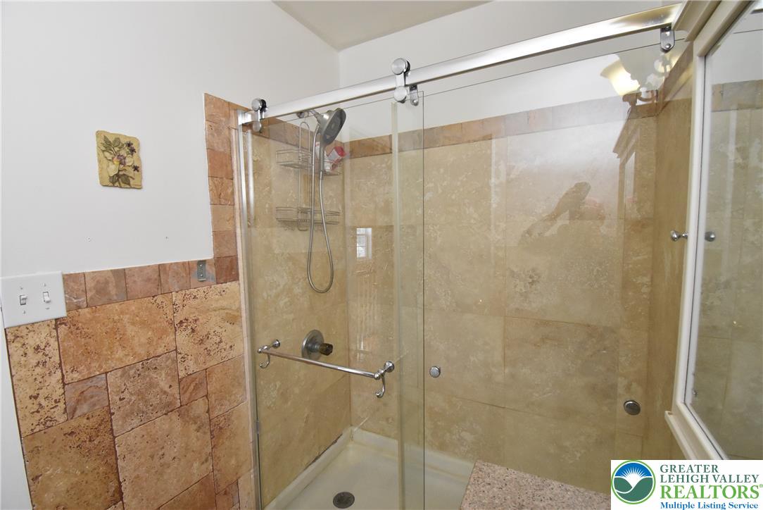 424 Grape Street Whitehall, PA 18052 - Photo 45 of 56 Shower with sliding glass doors and elegant tile accents.