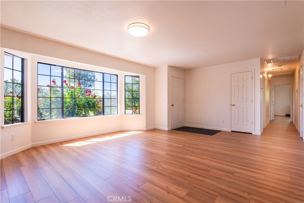 3729 Ben Hur Road Mariposa, CA 95338 - Photo 37 of 57 a view of an empty room with wooden floor and a window