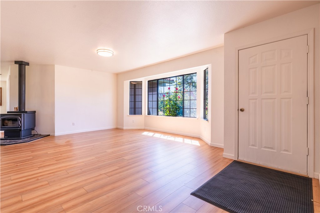 3729 Ben Hur Road Mariposa, CA 95338 - Photo 39 of 57 an empty room with wooden floor and windows