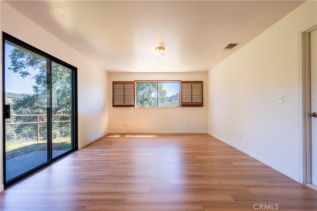 3729 Ben Hur Road Mariposa, CA 95338 - Photo 40 of 57 a view of empty room with wooden floor and fan