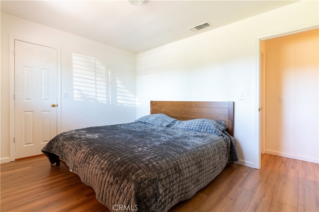 3729 Ben Hur Road Mariposa, CA 95338 - Photo 42 of 57 a bedroom with a bed and wooden floor