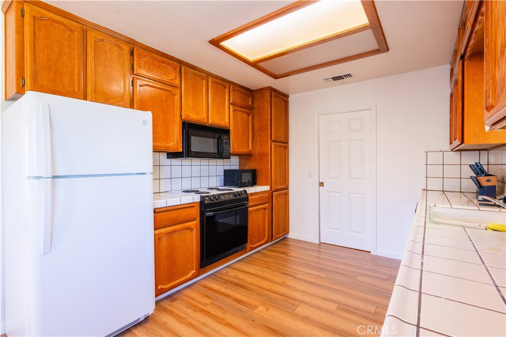 3729 Ben Hur Road Mariposa, CA 95338 - Photo 44 of 57 a kitchen with granite countertop a refrigerator and a stove top oven