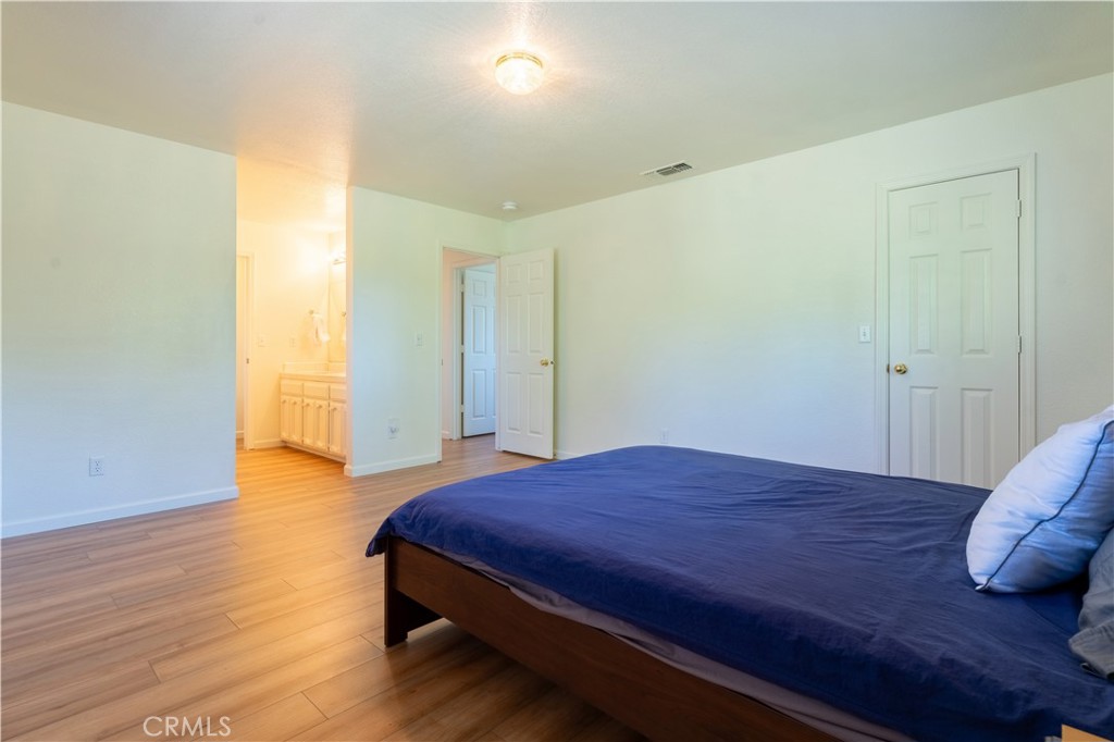 3729 Ben Hur Road Mariposa, CA 95338 - Photo 47 of 57 a bedroom with a bed and wooden floor